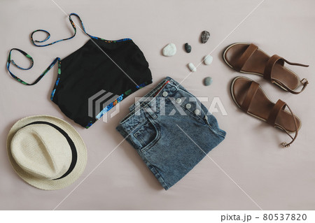 flat lay composition of summer outfit with swimsuit, denim shorts, straw hat and sandals. vacation on sea concept flat lay composition of summer outfit with swimsuit, denim shorts, straw hat and sandals. vacation on sea concept 80537820