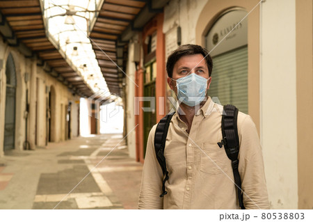 Empty streets city, closed shops, no people market of Cyprus city of paphos during national lockdown.Bankrupt during coronavirus outbreak. Masked tourist walks through closed market in old town 80538803