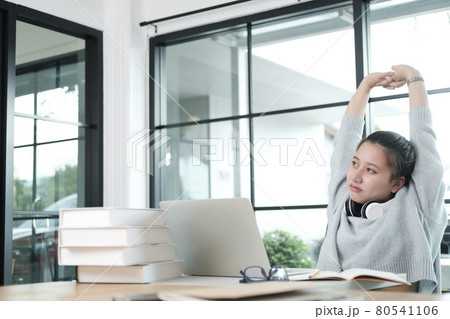 Young student in casual suit reading and doing stretch oneself 80541106