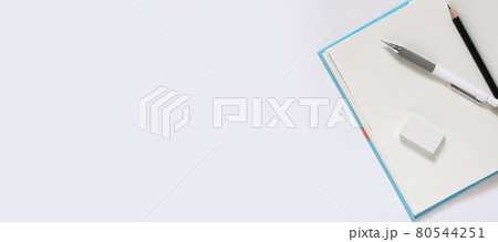 open notebook with blank pages workplace composition, White pencil eraser black pencil for drawing on a white table for school concept with copy space, Top view, flat lay 80544251