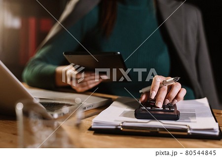 justice and law concept.businessman or lawyer or accountant working on accounts using a smart phone laptop digital tablet calculator and documents in dark office . justice and law concept.businessman or lawyer or accountant working on accounts using a smart phone laptop digital tablet calculator and documents in dark office . 80544845