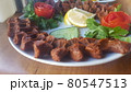 Cig kofte (raw meatball) with lettuce, tomato, pickle and lemon on the white plate. Turkish food Raw Meat ( Cig Kofte ) from traditional Turkish cuisine 80547513