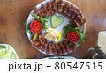 Cig kofte (raw meatball) with lettuce, tomato, pickle and lemon on the white plate. Turkish food Raw Meat ( Cig Kofte ) from traditional Turkish cuisine 80547515