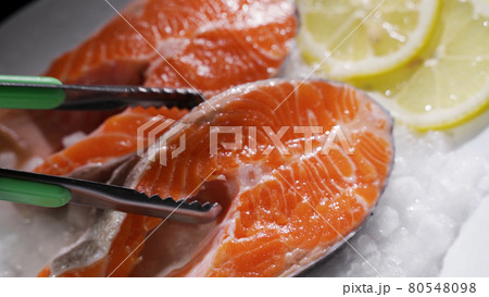 Salmon steaks and salmon fillet. Fresh salmon steaks and fillet are laid out on ice 80548098