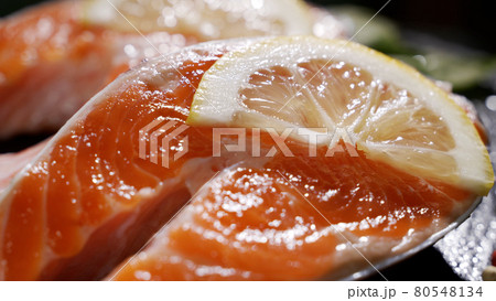 Salmon. Raw Trout Red Fish Steak with Herbs and Lemon and olive oil rotated on slate. Salmon. Raw Trout Red Fish Steak with Herbs and Lemon and olive oil rotated on slate. 80548134