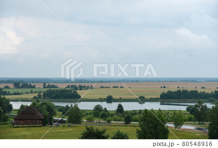 Beautiful cloudy landscape of a Belarusian village Beautiful cloudy landscape of a Belarusian village 80548916