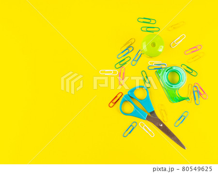 Back to school concept. Colorful office supply tools and clips on yellow Back to school concept. Colorful office supply tools and clips on yellow 80549625