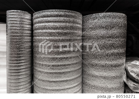 Silver rolls of insulation material, building materials in a hardware store Silver rolls of insulation material, building materials in a hardware store 80550271