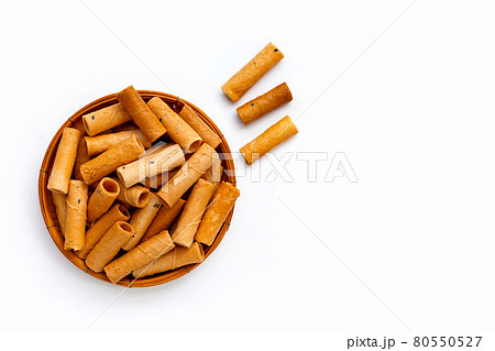 Thai crispy coconut rolls in bamboo basket on white background. 80550527