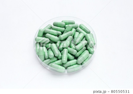 Green capsules on white background Green capsules on white background 80550531
