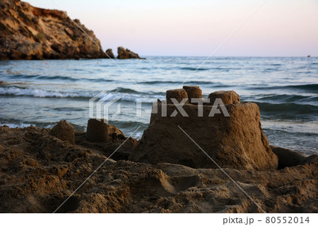 Sandcastle on the seashore in the evening. 80552014