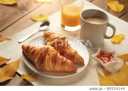 breakfast with cup of coffee, croissants, jam, fresh orange juice  80554144