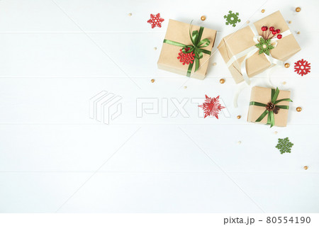 Three gift boxes wrapped in kraft paper on white wood desk background Three gift boxes wrapped in kraft paper on white wood desk background 80554190