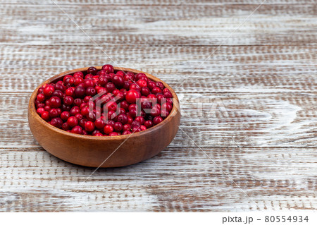 Bowl of fresh cranberry on wooden background, horizontal, copy space 80554934