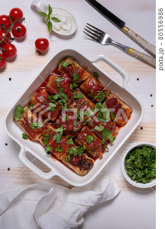 Baked cabbage rolls in white square baking pan flat lay 80556986