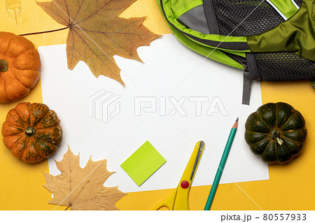 Backpack, school supplies, orange leaves and pumpkins. Flatlay background. Greeting card for Teachers Day 80557933
