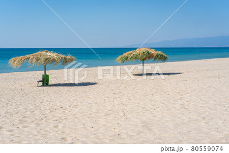 Two beach umbrela on sandy beach 80559074