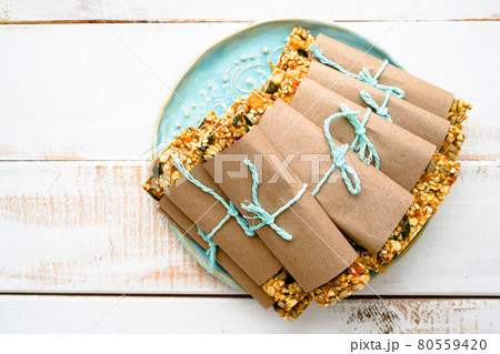 Granola bars with seeds on white wooden background 80559420