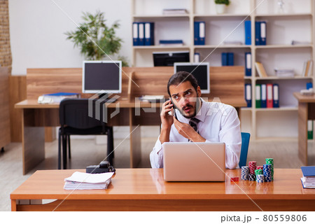 Young male employee in gambling concept Young male employee in gambling concept 80559806