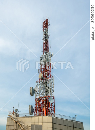 Large telecommunication tower against sky and clouds in background 80560250