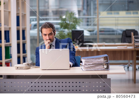 Young male employee working in the office Young male employee working in the office 80560473