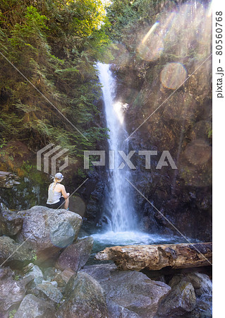 Adult Woman hiker at Norvan Falls and river stream in the natural canyon Adult Woman hiker at Norvan Falls and river stream in the natural canyon 80560768