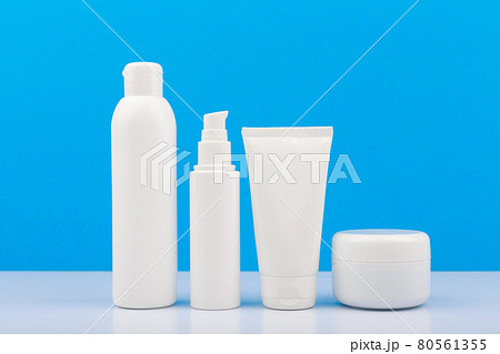 Set of cosmetic products for daily skincare on white table against blue background Set of cosmetic products for daily skincare on white table against blue background 80561355