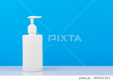 Shower gel or liquid soap on white shelf against bright blue with space for text 80561361
