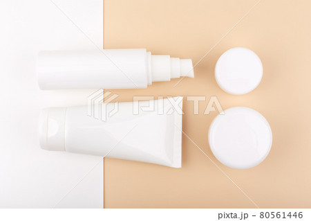 Flat lay with set of beauty products for daily skin care on white and beige background Flat lay with set of beauty products for daily skin care on white and beige background 80561446