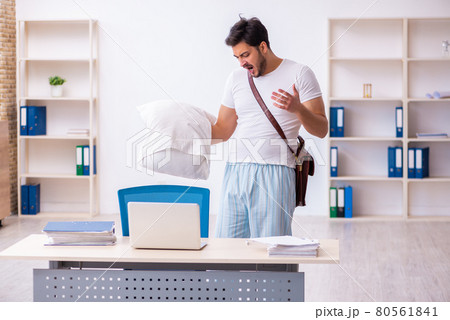 Young male employee coming to work straight from bed 80561841
