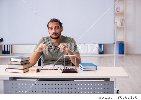 Young male student preparing for exams in the classroom Young male student preparing for exams in the classroom 80562150