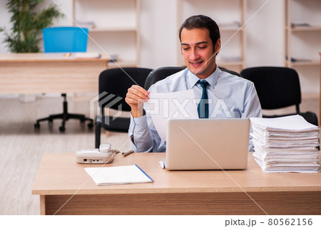 Young male employee unhappy with excessive work Young male employee unhappy with excessive work 80562156