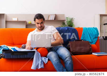 Young man student preparing for trip at home 80562874