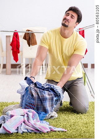 Handsome man husband doing laundering at home 80563105