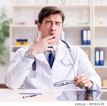 Young doctor sitting in the office Young doctor sitting in the office 80563139