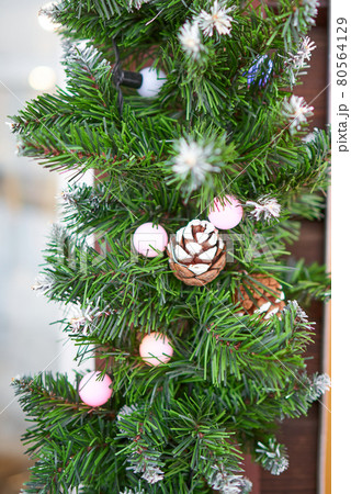 Happy new year artificial spruce branches and cones on wooden corner 80564129