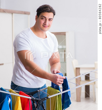 Man doing laundry at home 80564282