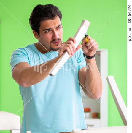 Man repairing furniture at home Man repairing furniture at home 80564724