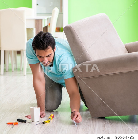 Man repairing furniture at home Man repairing furniture at home 80564735