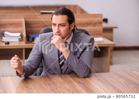 Young businessman employee sitting in the office Young businessman employee sitting in the office 80565732