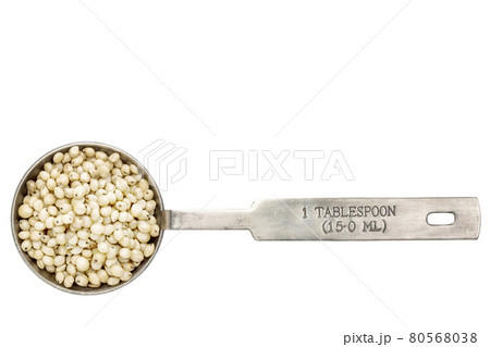 sorghum grain in a tablespoon 80568038