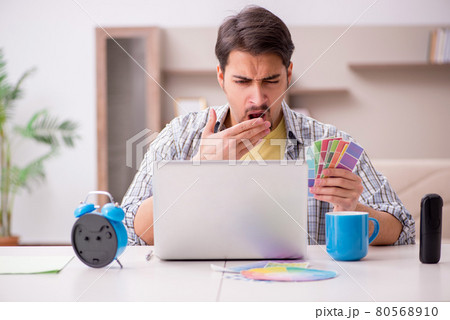 Young male freelancer in time management concept at home 80568910