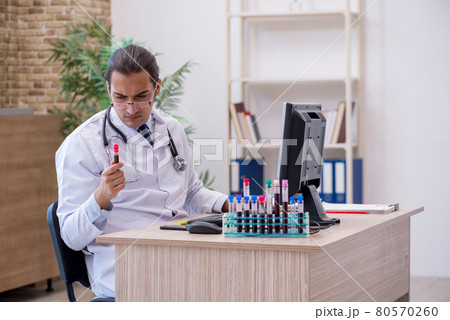 Young male doctor cardiologist working in the clinic 80570260