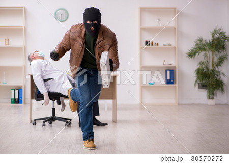 Masked man burglar stealing vaccine from old doctor Masked man burglar stealing vaccine from old doctor 80570272