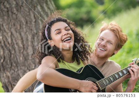 Laughing happy girl with guy in nature Laughing happy girl with guy in nature 80576153