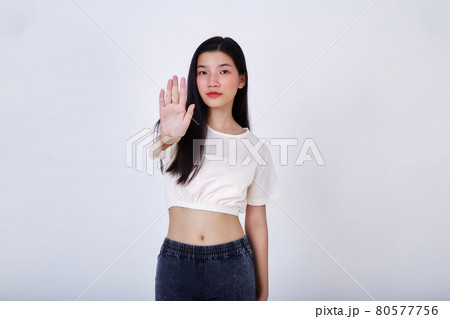 Young serious beautiful woman showing stop sign Young serious beautiful woman showing stop sign 80577756