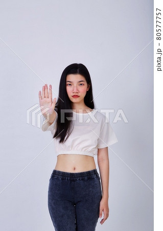 Young serious beautiful woman showing stop sign 80577757