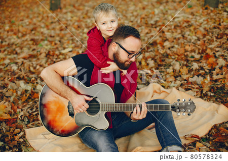 Cute family playing in a autumn park Cute family playing in a autumn park 80578324