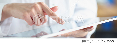 Medical officer doctor points his finger at tablet Medical officer doctor points his finger at tablet 80579559