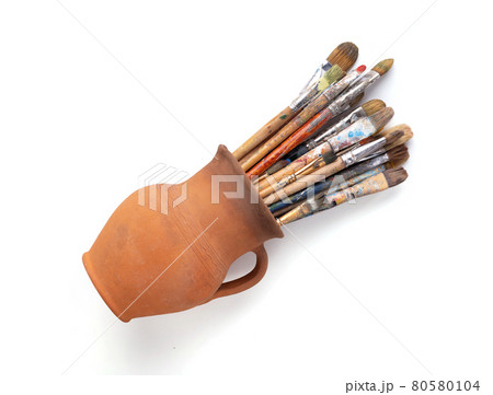 Paint brush in clay jug for art painting isolated on white background. Paintbrush for oil painting 80580104